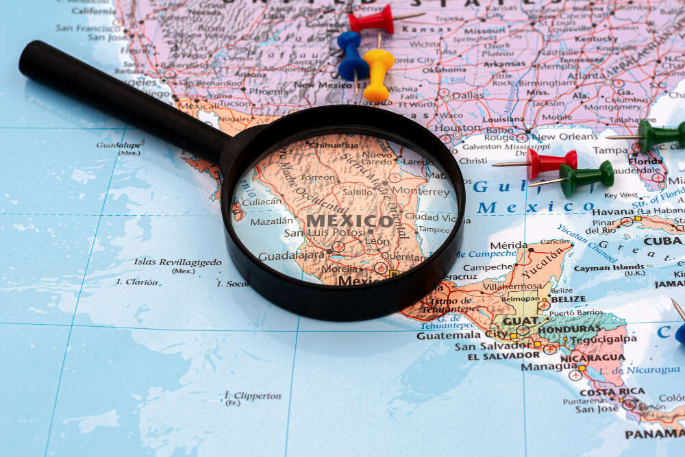 magnifying glass world map selective focus mexico map economic business concept 1